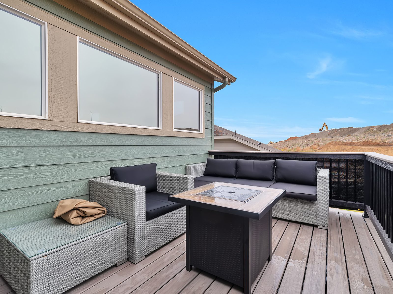 Covered deck with a fire table and seating