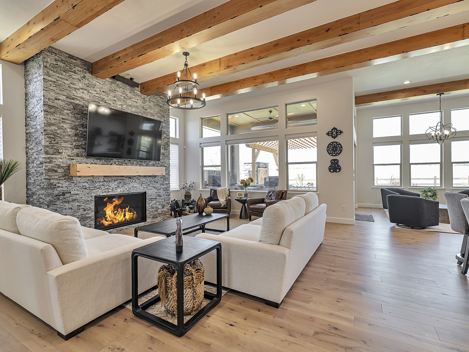 Renovated great room with stone fireplace and wood beams